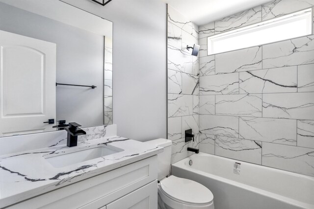 full bathroom featuring vanity, toilet, and tiled shower / bath