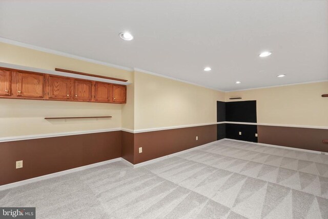 empty room with light carpet, recessed lighting, baseboards, and ornamental molding