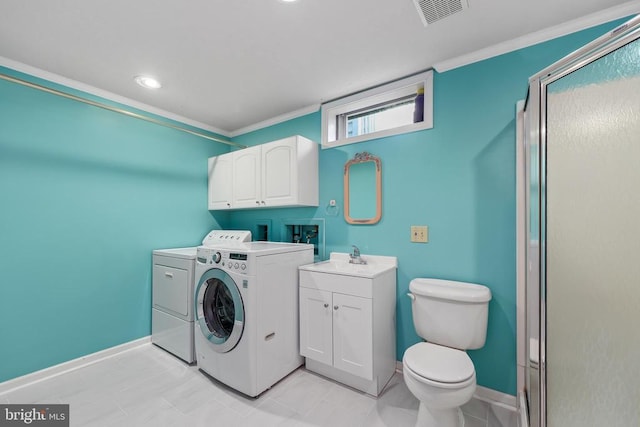 clothes washing area with visible vents, crown molding, laundry area, separate washer and dryer, and a sink