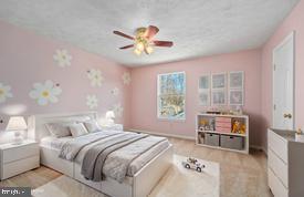 bedroom featuring wood finished floors and ceiling fan