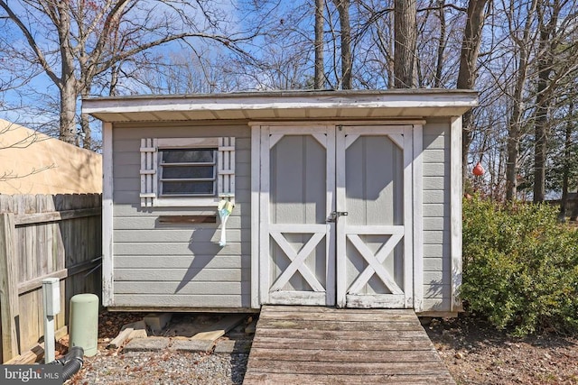 view of shed featuring fence