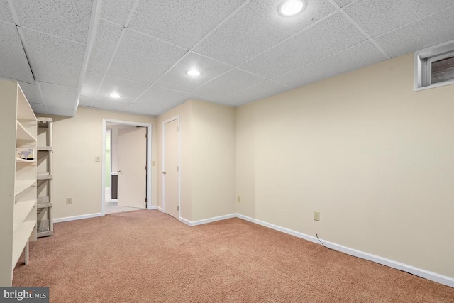 finished below grade area featuring recessed lighting, a paneled ceiling, baseboards, and carpet flooring