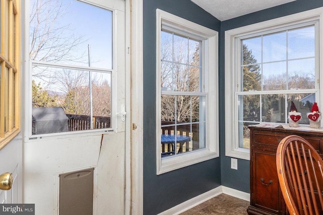 entryway with baseboards and a textured ceiling