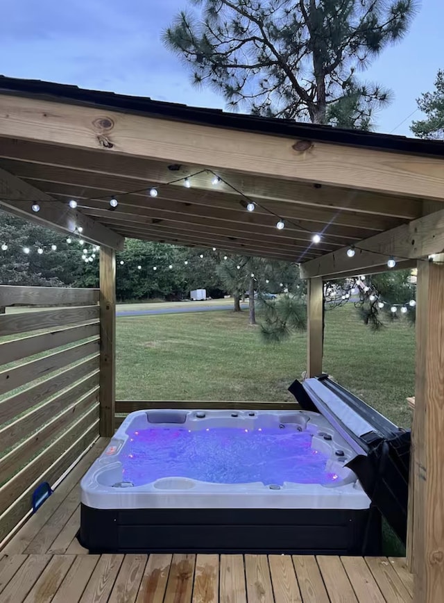 deck with hot tub deck surround and a yard