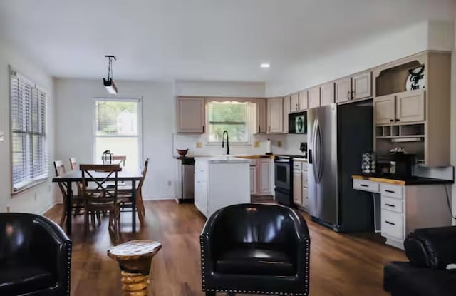 kitchen featuring plenty of natural light, dark wood-style floors, and appliances with stainless steel finishes
