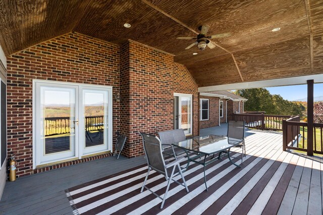 wooden deck with ceiling fan and french doors