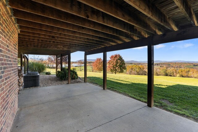 view of patio / terrace featuring a mountain view and central AC unit