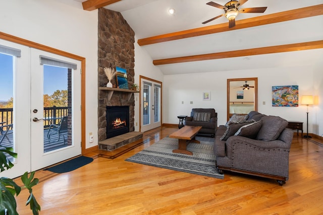 living room with french doors, a fireplace, beam ceiling, and hardwood / wood-style flooring