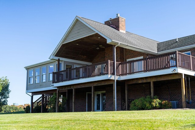 back of property featuring a yard and a deck