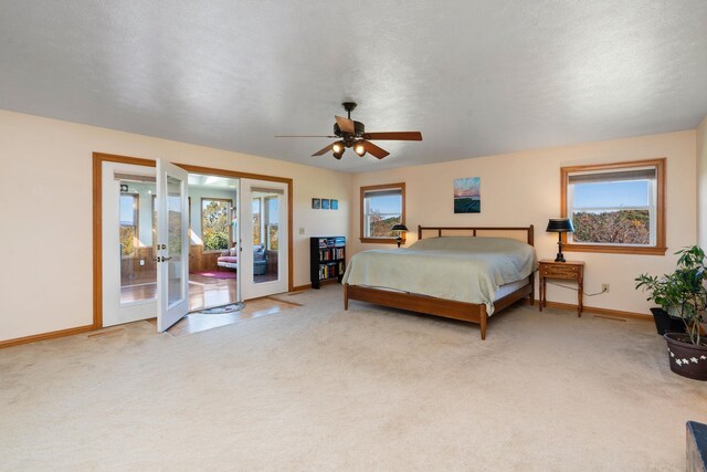 bedroom featuring light colored carpet, access to exterior, ceiling fan, a textured ceiling, and french doors