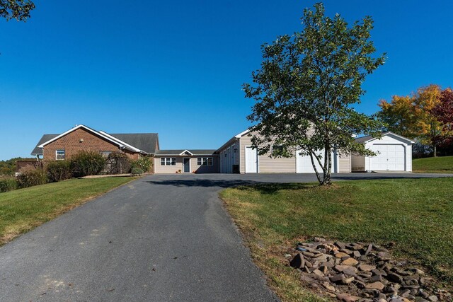 ranch-style home featuring a garage and a front yard