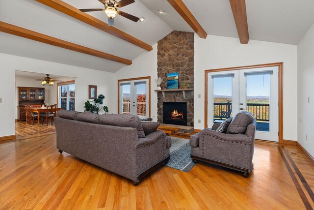 living room with hardwood / wood-style flooring, high vaulted ceiling, beam ceiling, and french doors