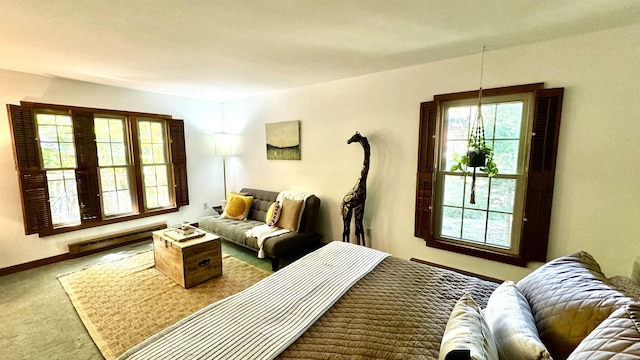 carpeted bedroom with a baseboard radiator