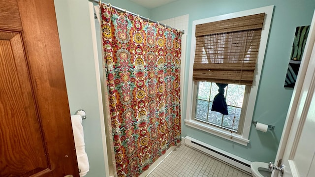 bathroom with a baseboard radiator, tile patterned floors, and toilet