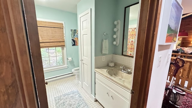 bathroom with tile patterned floors, toilet, vanity, and a baseboard heating unit