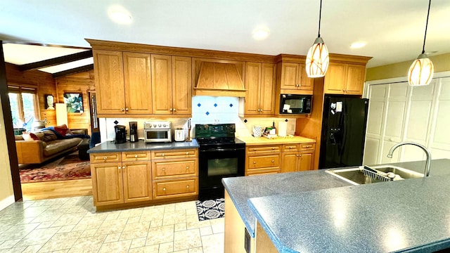 kitchen with custom exhaust hood, hanging light fixtures, sink, and black appliances