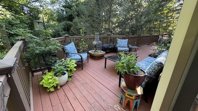 wooden terrace featuring an outdoor living space