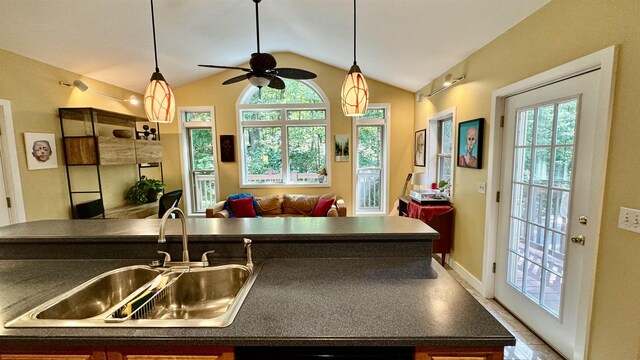 kitchen with lofted ceiling, sink, dishwashing machine, and a healthy amount of sunlight