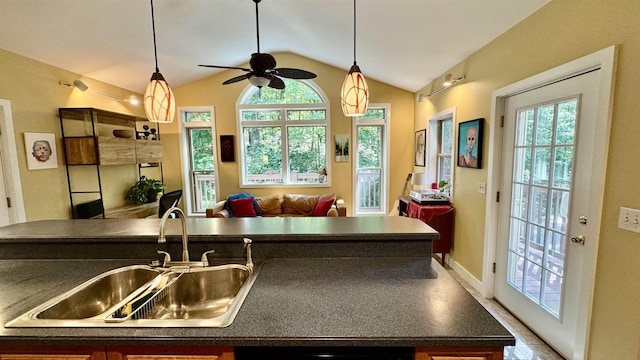 kitchen with lofted ceiling, sink, dishwashing machine, and a healthy amount of sunlight