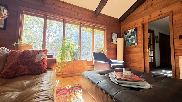 living room featuring vaulted ceiling with beams, wooden walls, and hardwood / wood-style floors