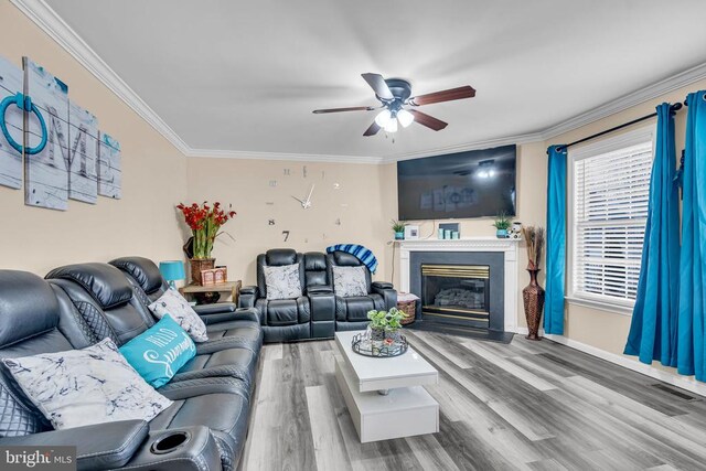 living room with crown molding, ceiling fan, and hardwood / wood-style flooring