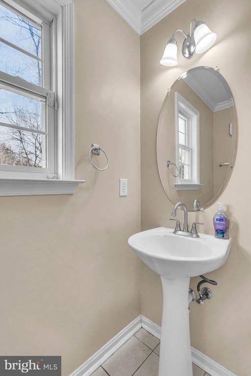 bathroom with tile patterned flooring, sink, and ornamental molding