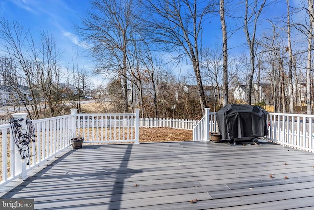 wooden deck with a grill