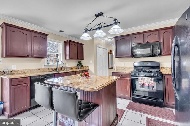 kitchen featuring crown molding, light tile patterned floors, hanging light fixtures, and black appliances