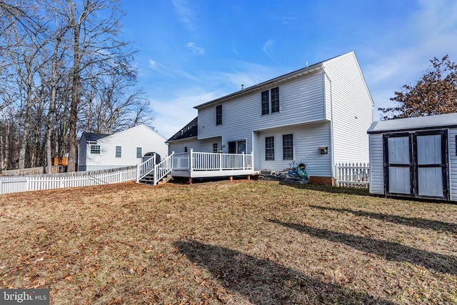 back of house with a storage unit, a deck, and a lawn