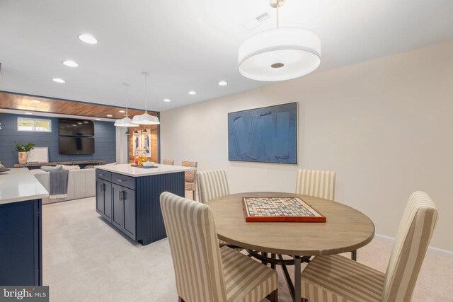 dining area featuring light colored carpet