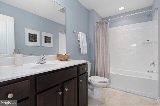 full bathroom with shower / tub combo with curtain, vanity, toilet, and tile patterned flooring