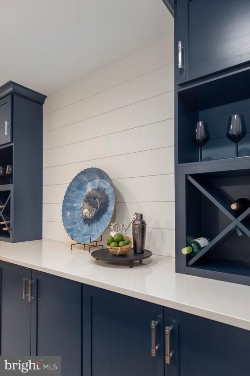 bar featuring blue cabinetry