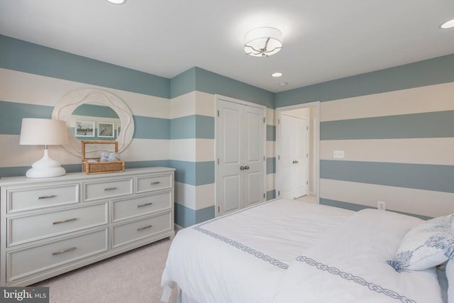 bedroom featuring light colored carpet and a closet