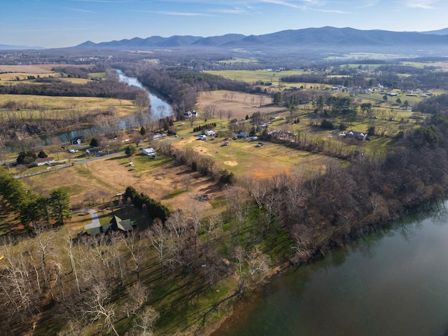 birds eye view of property featuring a water and mountain view and a rural view
