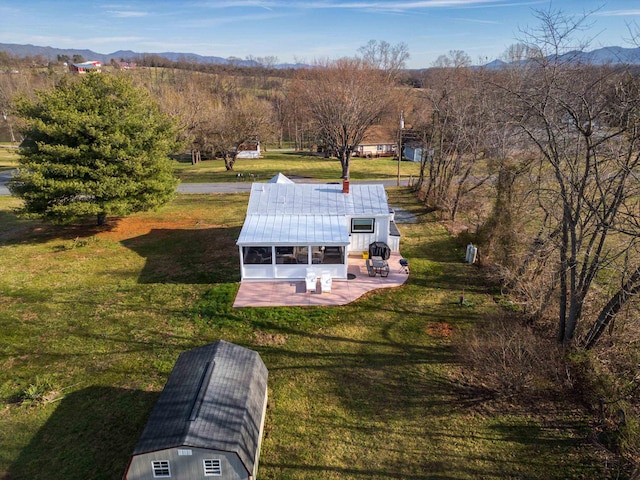 birds eye view of property with a mountain view