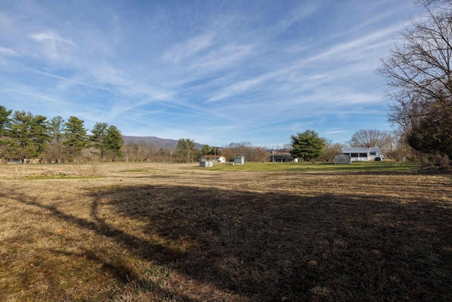 view of yard featuring a rural view and a mountain view