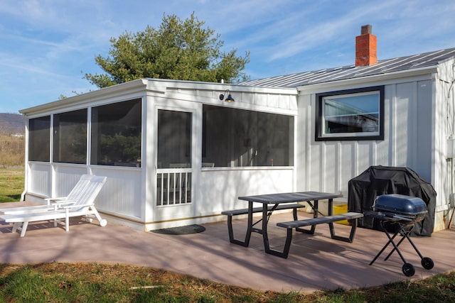 exterior space with grilling area and a sunroom