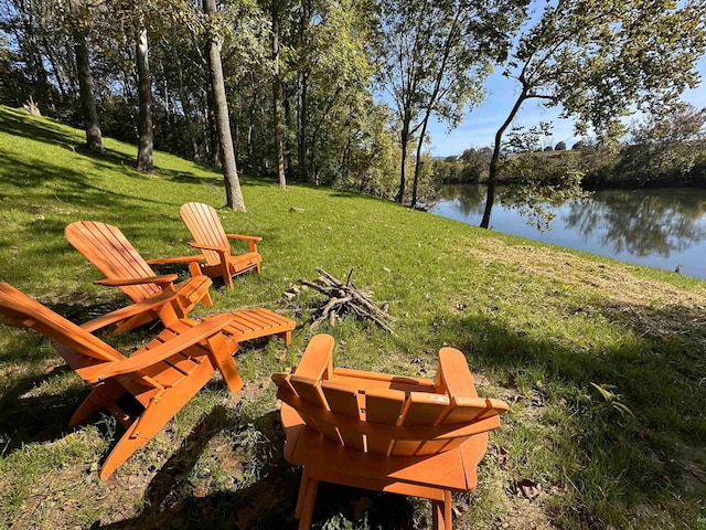 view of yard with a water view and an outdoor fire pit