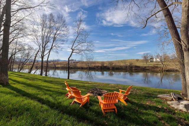 view of yard with a water view and an outdoor fire pit
