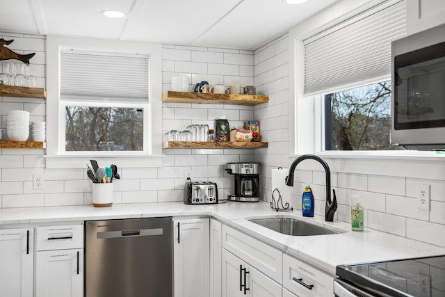 kitchen featuring a sink, stainless steel appliances, open shelves, and white cabinetry