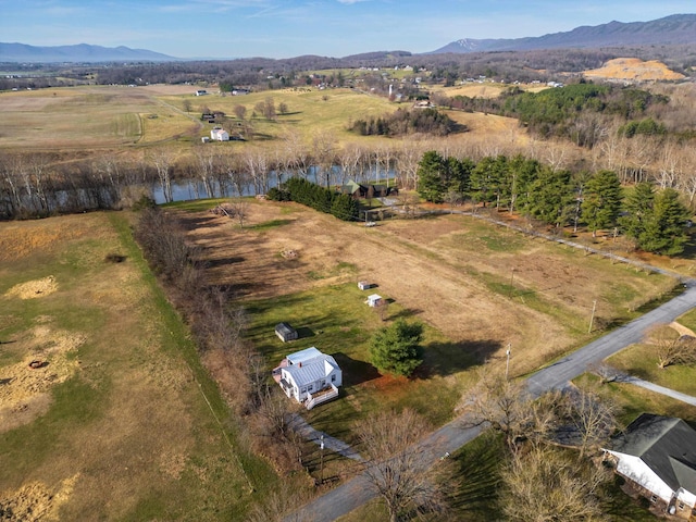 aerial view featuring a rural view and a water and mountain view