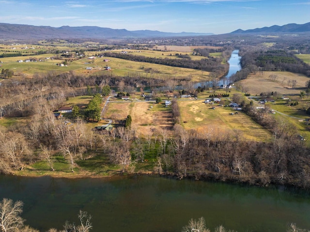 drone / aerial view featuring a water and mountain view