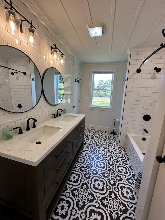 bathroom featuring a sink, decorative backsplash, double vanity, and tile patterned flooring