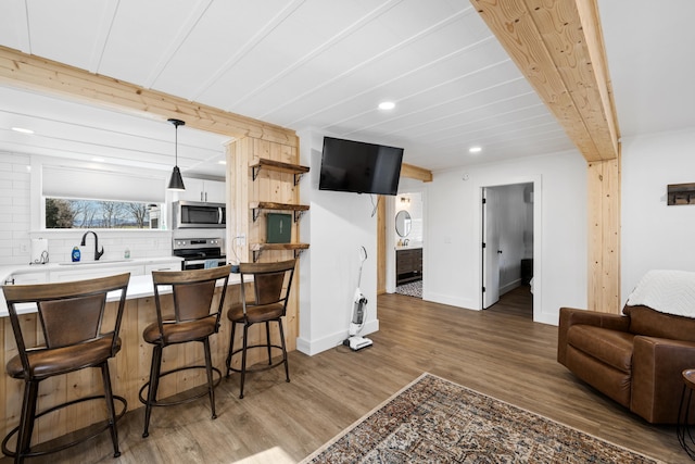 kitchen with beam ceiling, open shelves, tasteful backsplash, appliances with stainless steel finishes, and light wood finished floors