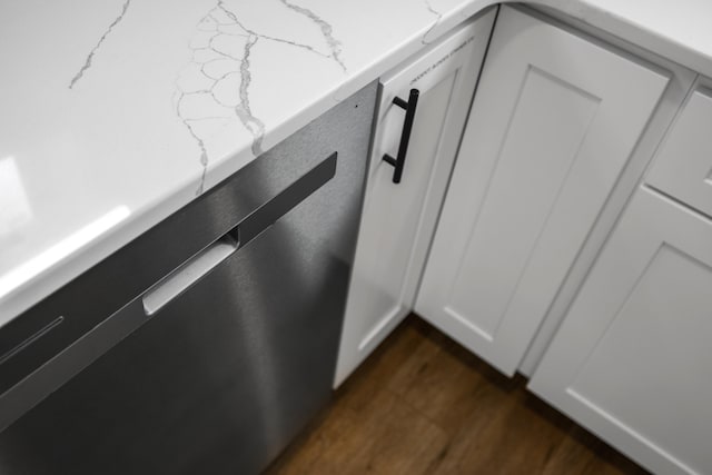 details with light stone counters and dark wood finished floors