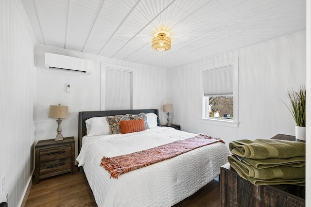bedroom featuring wood finished floors and a wall mounted AC