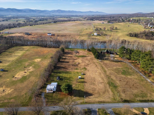 birds eye view of property with a mountain view and a rural view