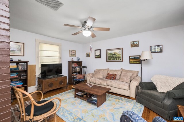 living room featuring hardwood / wood-style flooring and ceiling fan