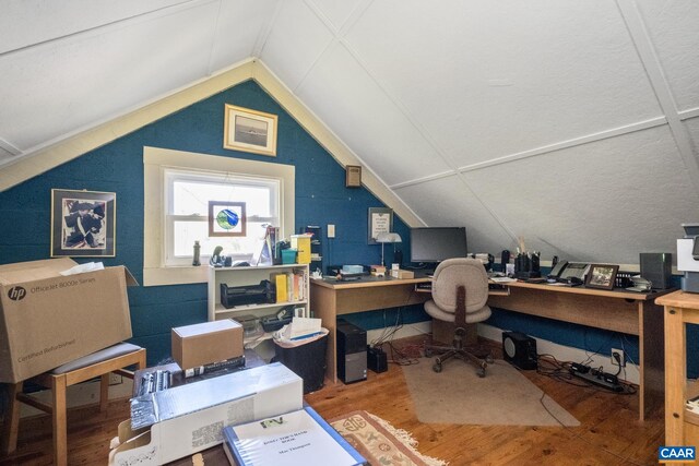 home office featuring lofted ceiling and wood-type flooring