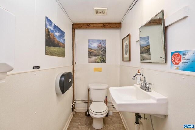 bathroom with tile patterned flooring, sink, and toilet